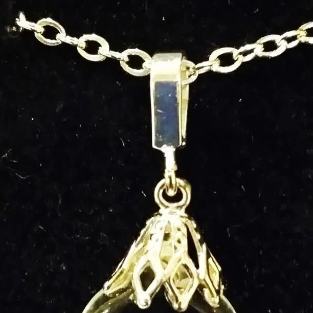 Clear glass drop with floating zirconia fragments, 2018 archive photograph